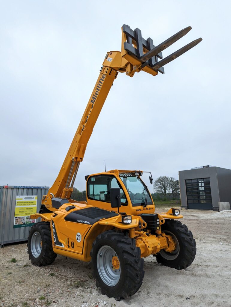 A large yellow forklift with a crane attached to it